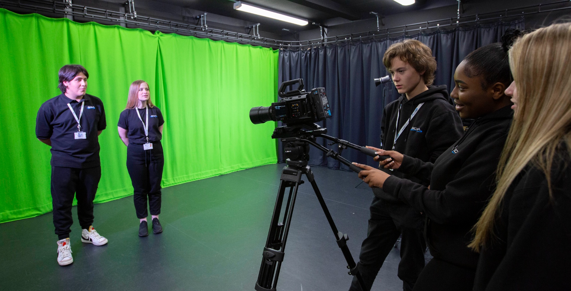 Students filming in Green Screen studio with camera on a tripod